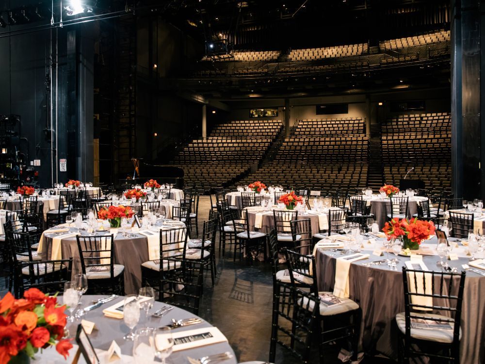 Picture of a seated dinner onstage.