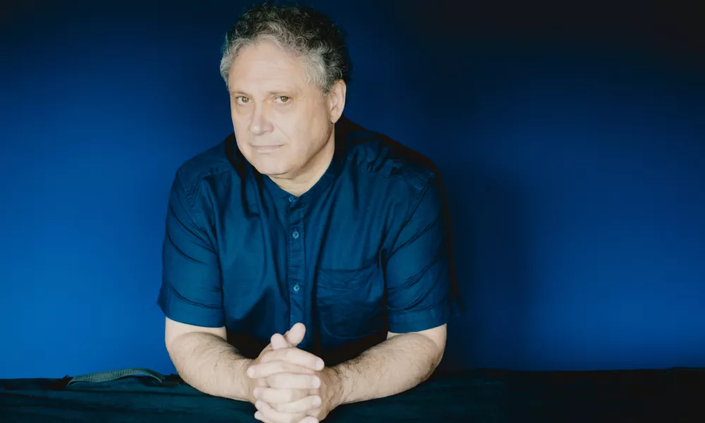 Headshots for Richard Egarr. A man in a button up shirt. 