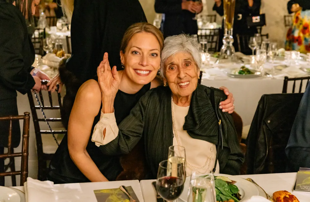 Harris Theater CEO and President, Lori Dimun, and Joan W. Harris smiling and posing together.