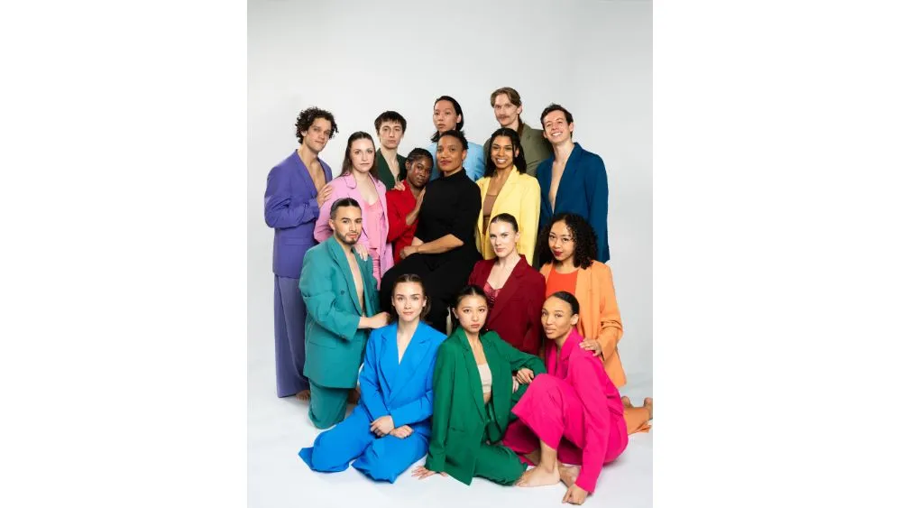 A group of dancers each in a different color pose together.