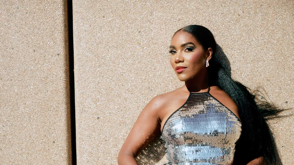 A woman in a sequenced sparkly dress. 