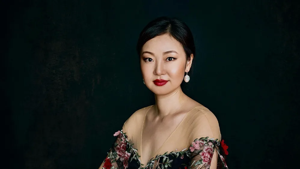 A woman in a floral dress. 
