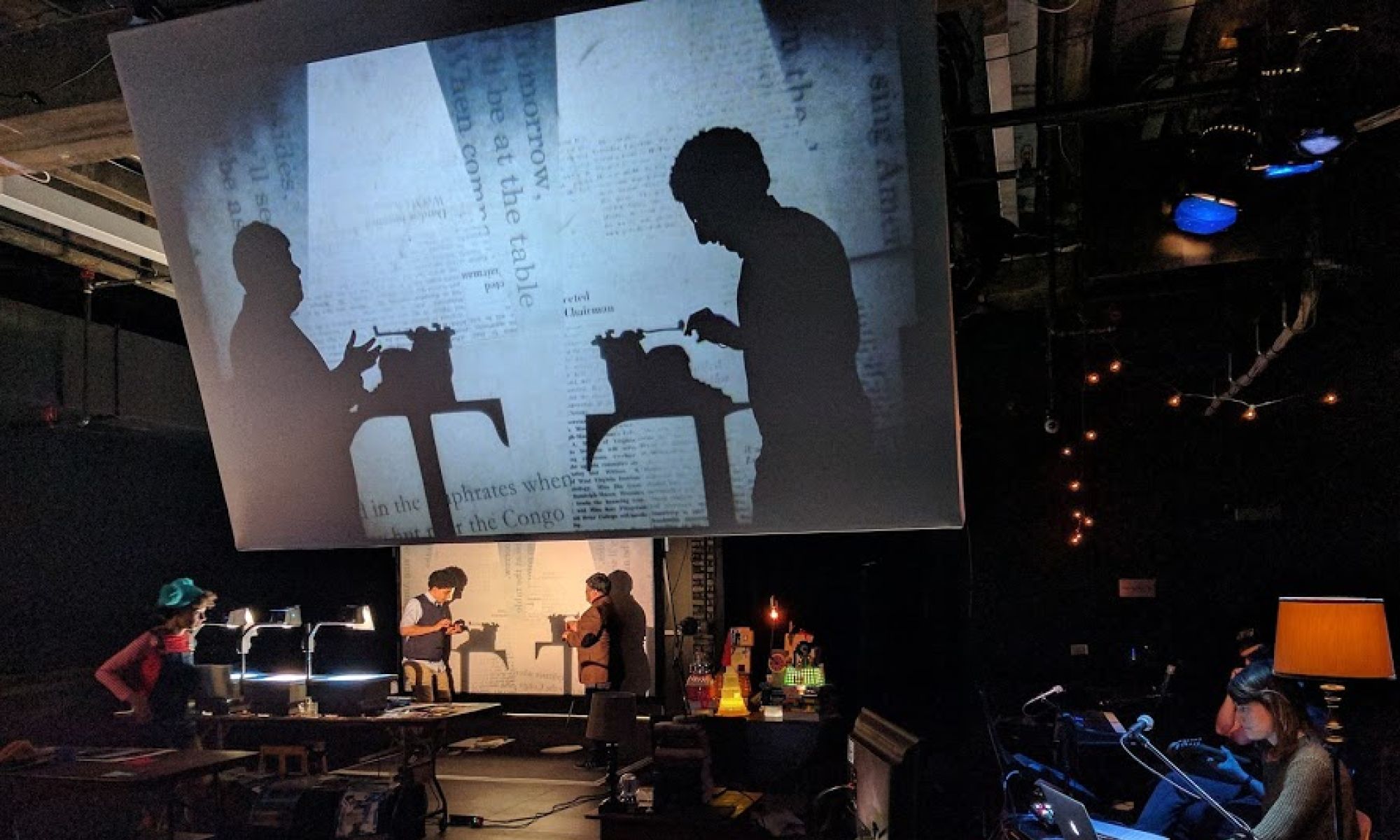 The set with a projection of two silhouettes from The Magic City