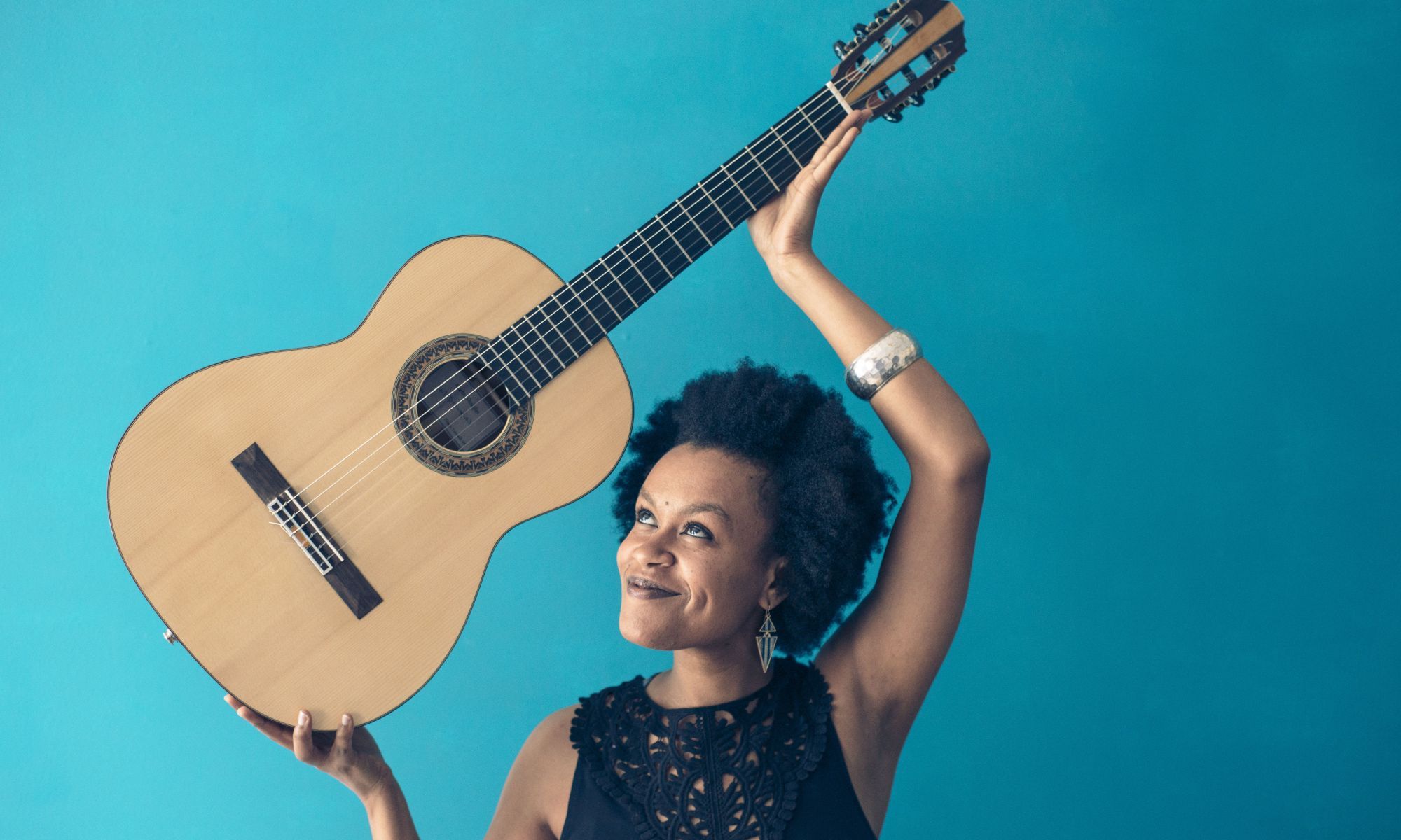 Woman holding a guitar above her head