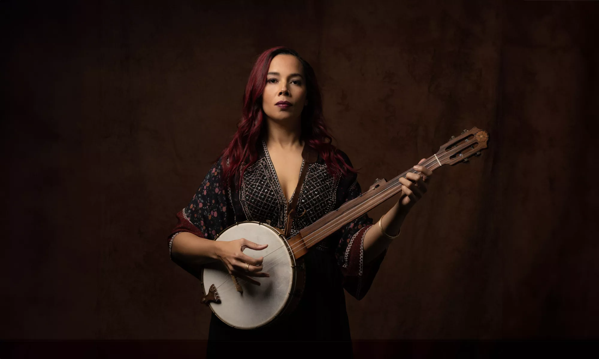 Rhiannon Giddens poses with her banjo. 