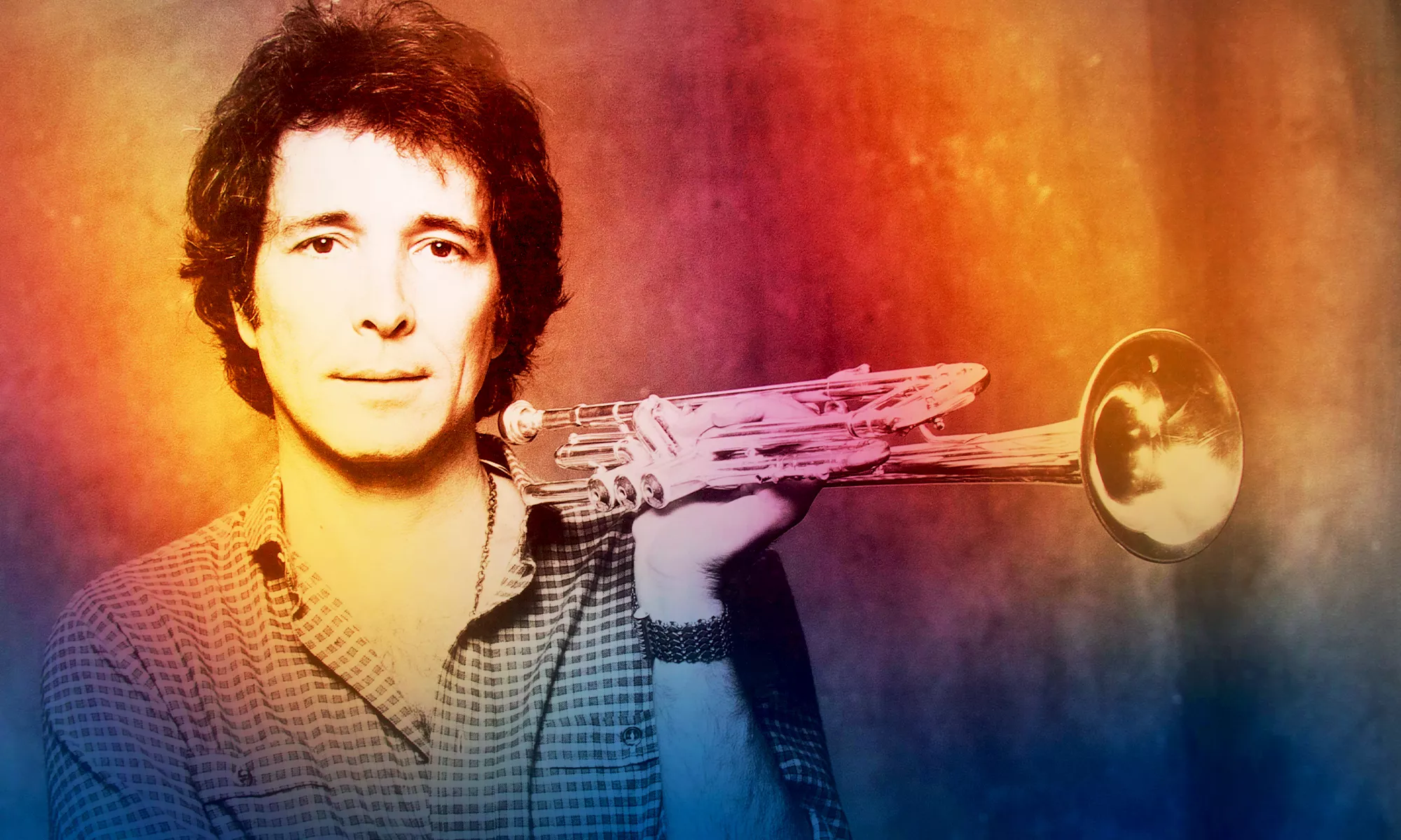 A man holding a trumpet. The image has a gradient effect. 