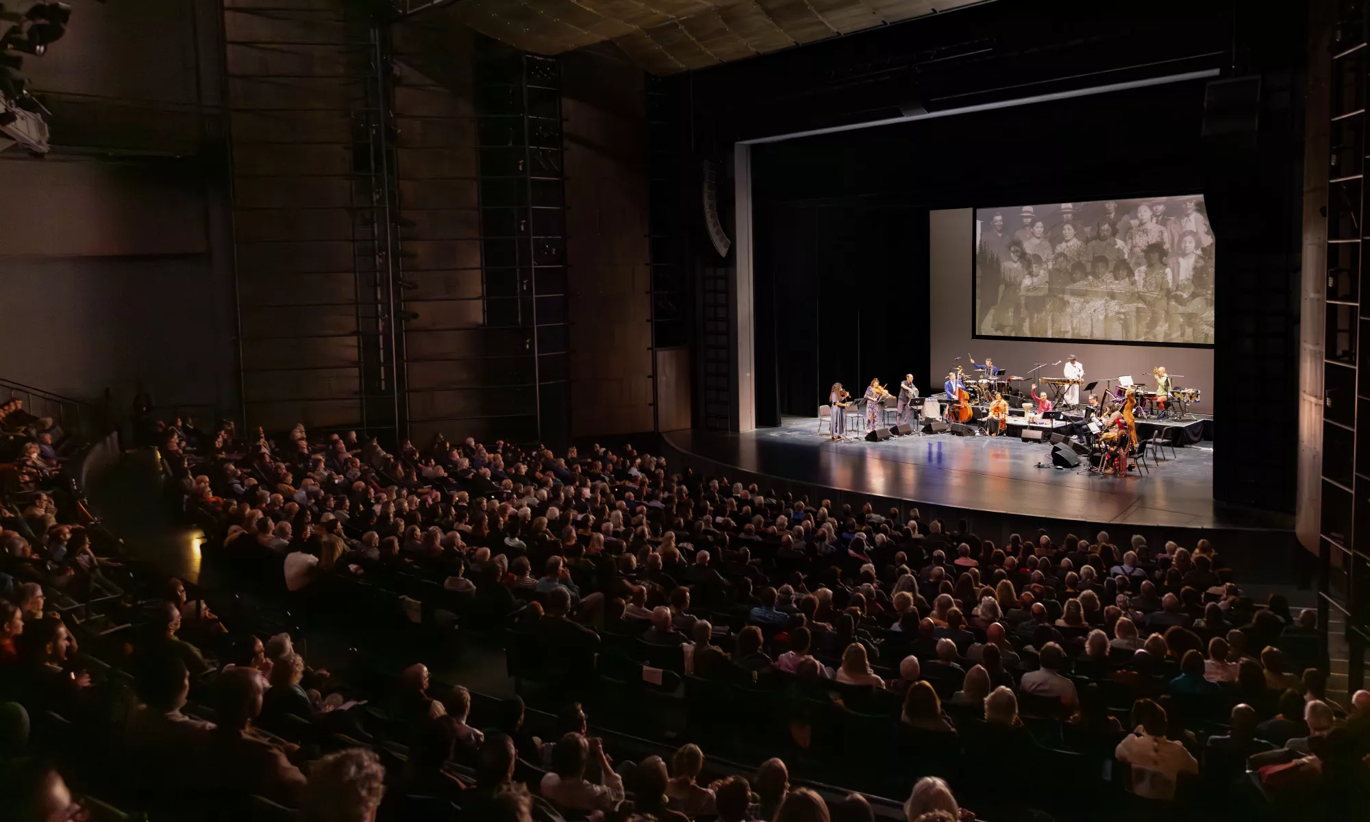The Harris Theater auditorium full of patrons watching a performance.