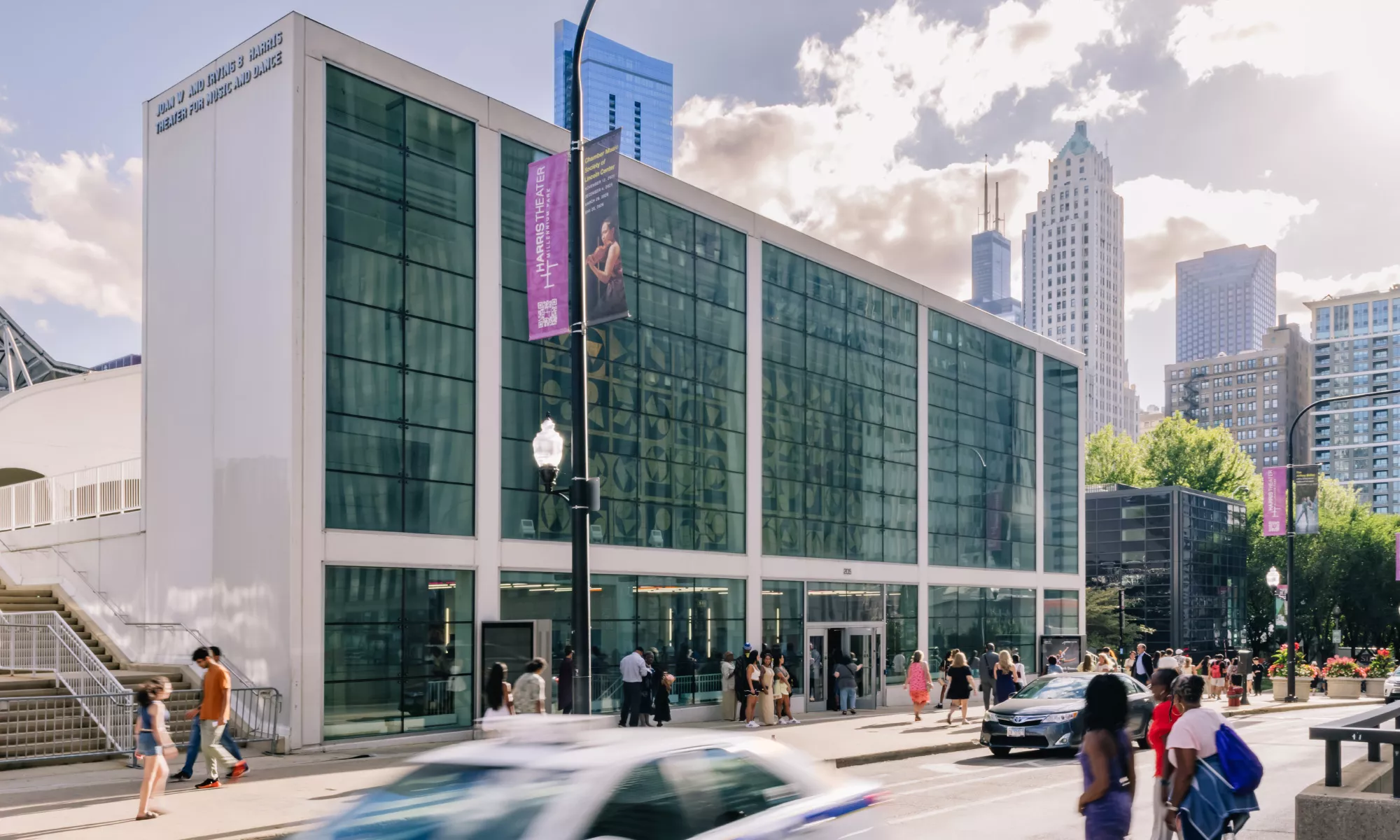 The Harris Theater exterior with a busy street. 