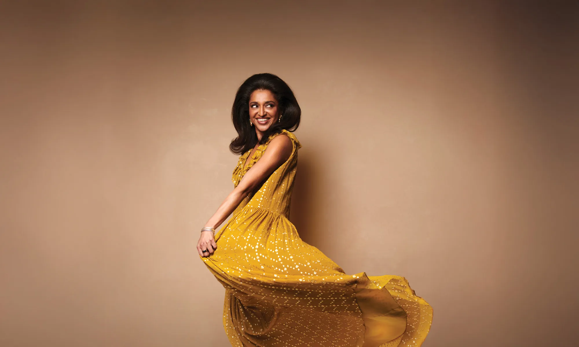 A woman twirling her yellow dress.