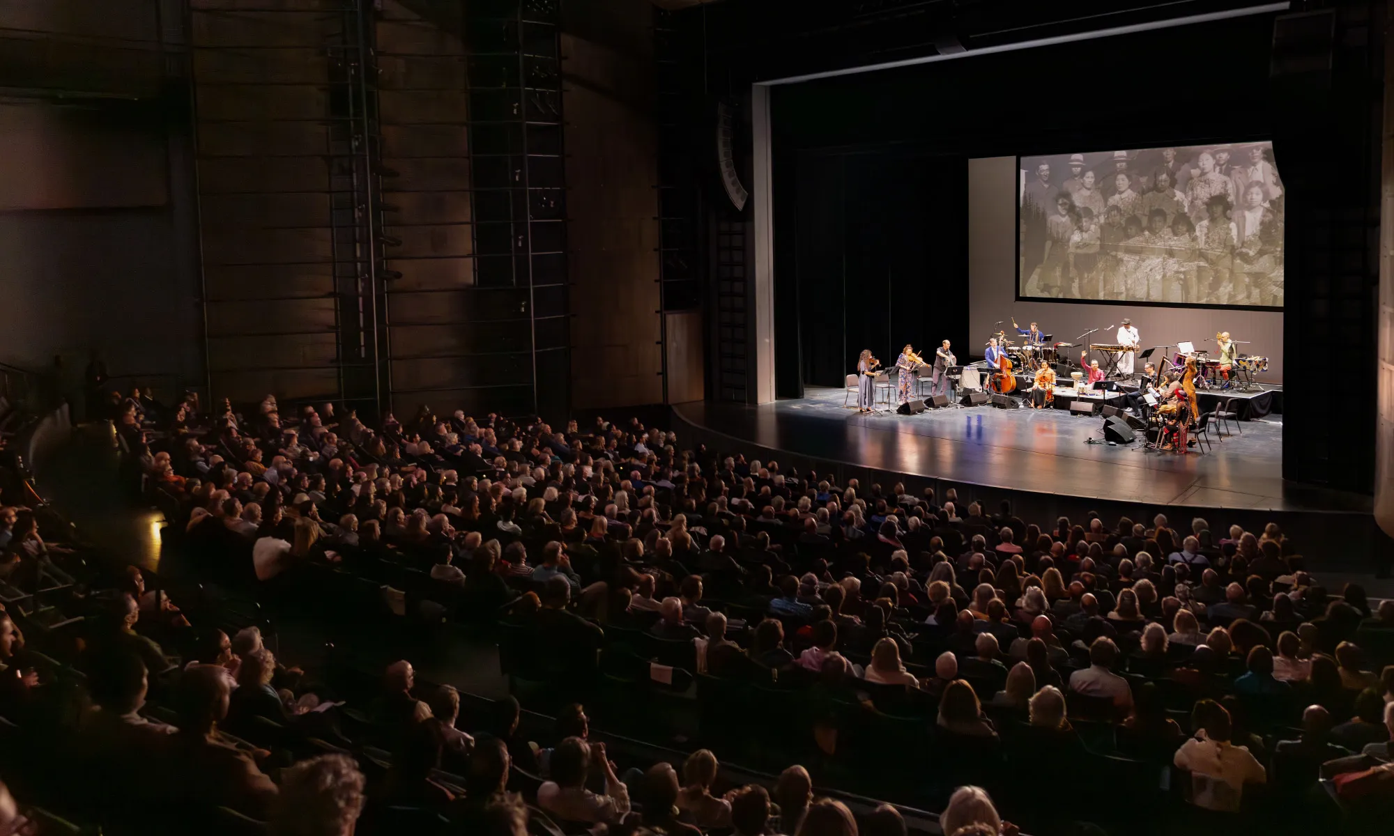 The Harris Theater auditorium full of patrons watching a performance.
