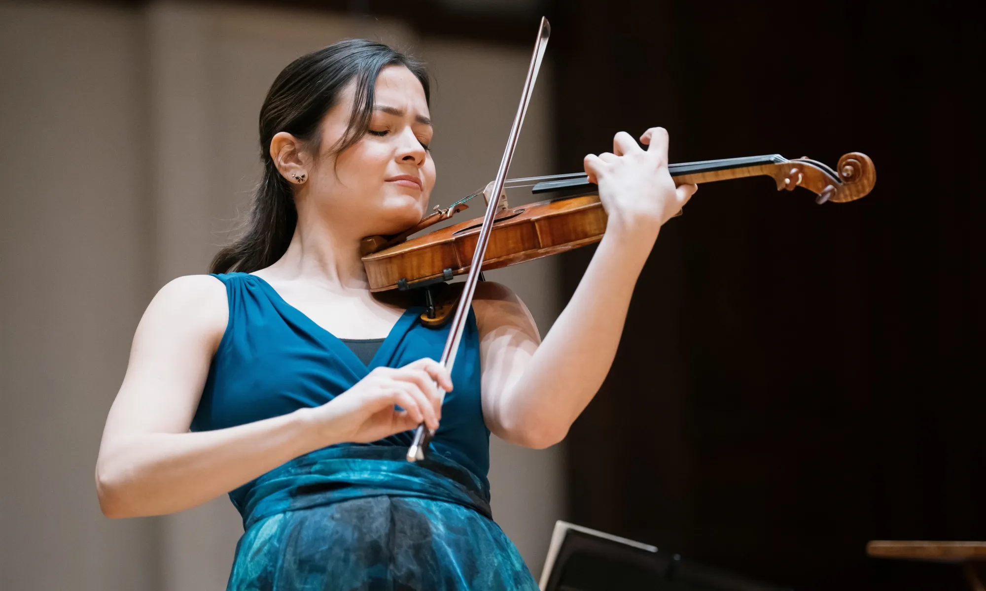 A woman playing the violin. 