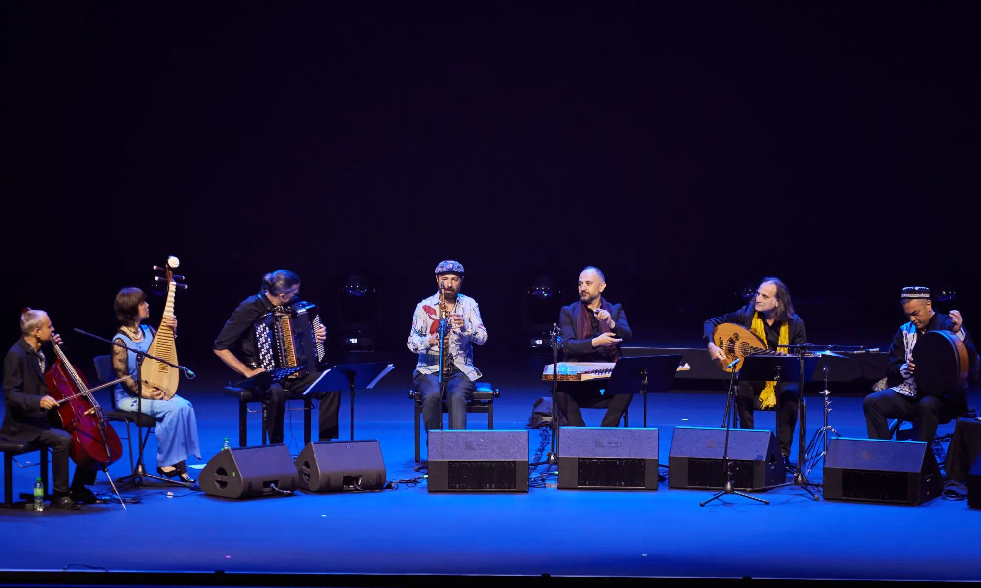 An ensemble of musicians on stage performing.