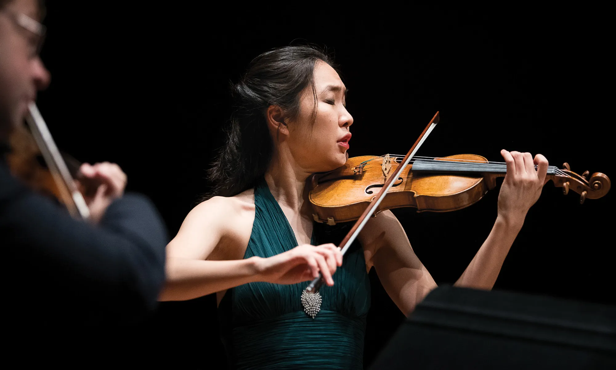 A woman playing the violin. 