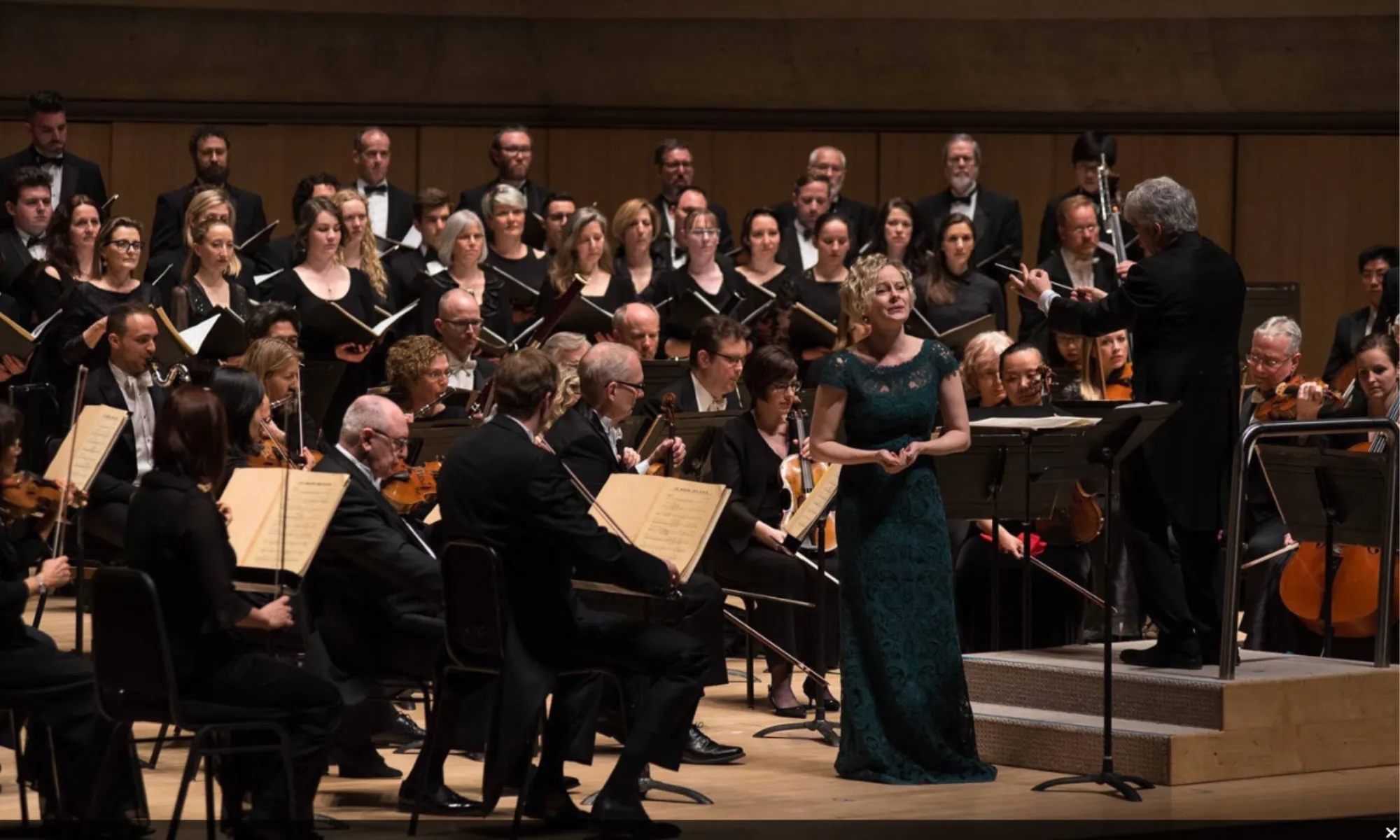 An opera singer performing with an orchestra.