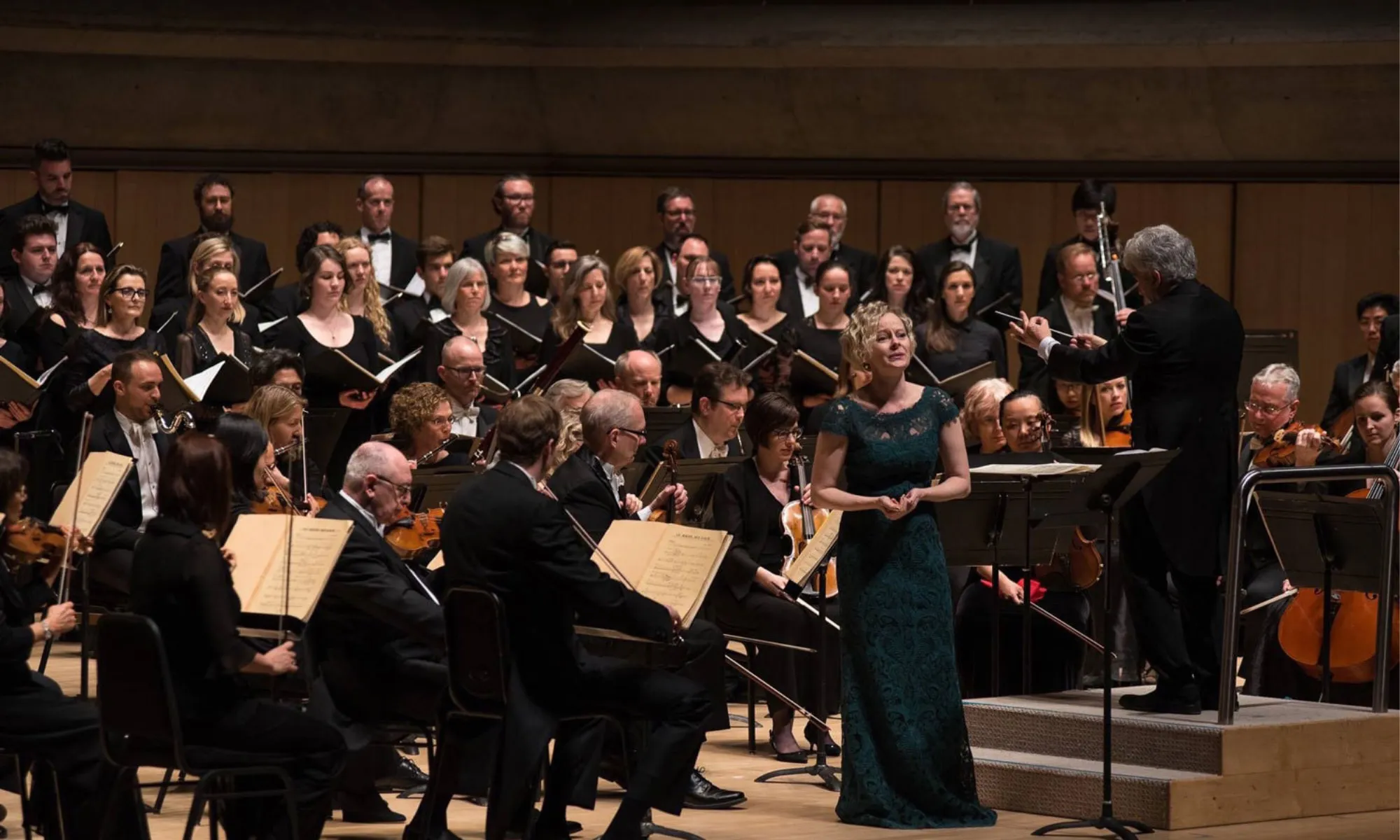 An orchestra and opera singer performing.