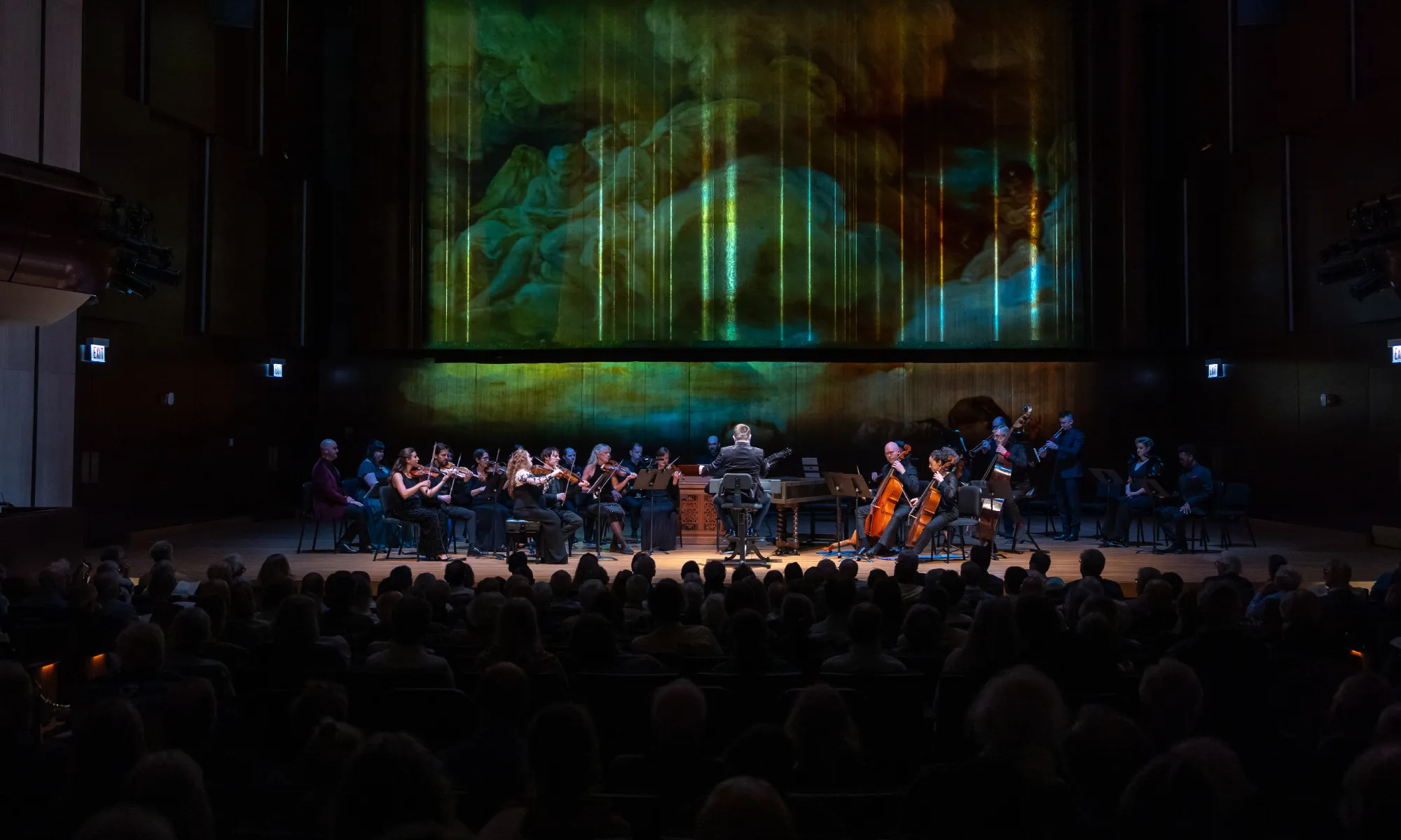 The Haymarket Opera Orchestra playing on stage in front of a full house.