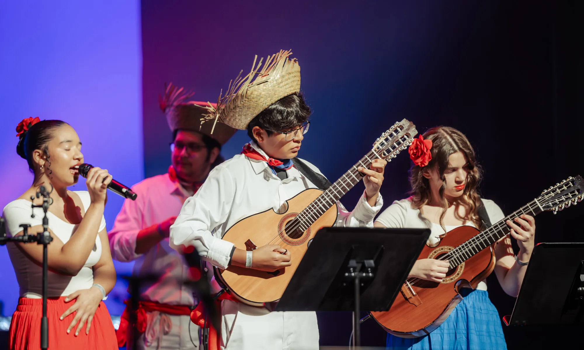 A few young musicians playing the Cuatro guitar and singing. 