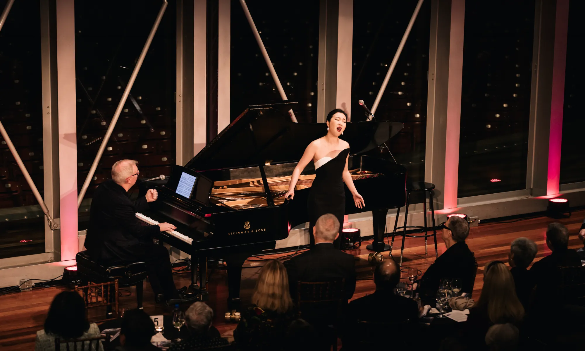 Ying Fang performing with Craig Terry in front of an audience. 