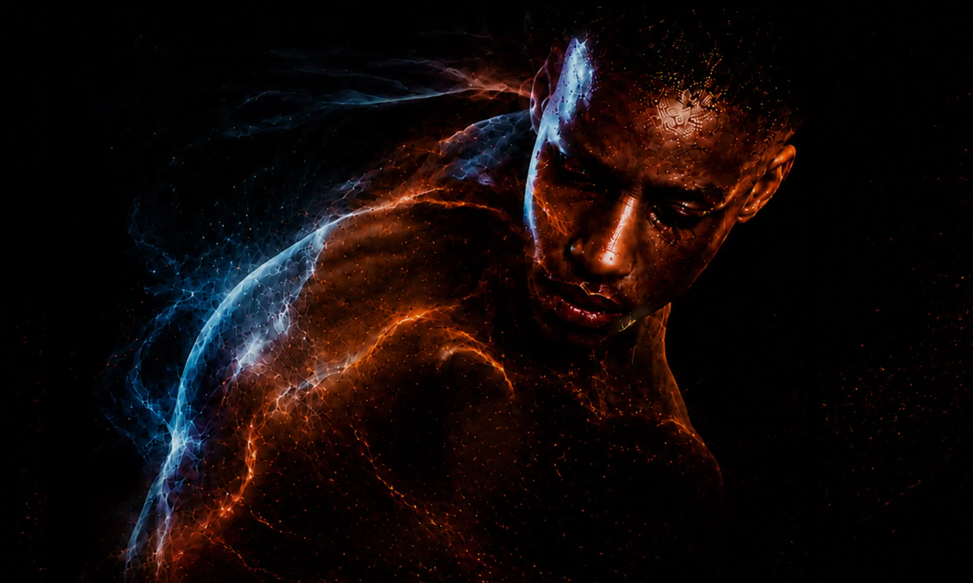 A dancer looking down shirtless. A string of blue and yellow lights cover their whole body.