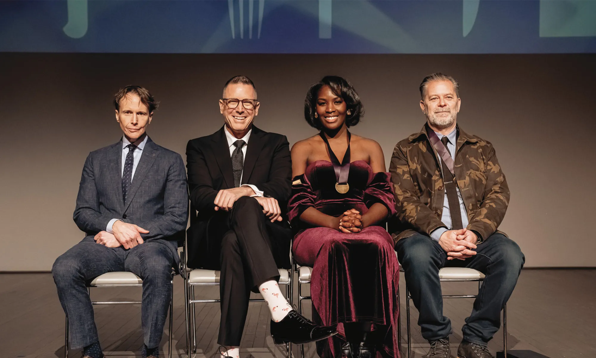 Four people sitting in a row.