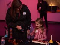 Mother and daughter visiting the instrument petting zoo in the HT Lobby.