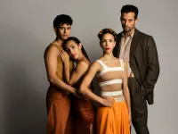 Four performers pose together. Two women and two men. One couple hugs each other.