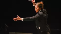 Lidiya Yankovskaya conducting with her arms stretched in front of her