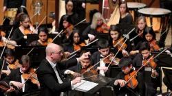 Conductor Michael Mascari instructing students playing instruments