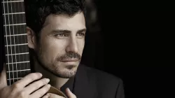 Pablo holding his guitar