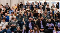 A group of people sitting and cheering.