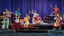 An ensemble of performers playing an assortment of instruments.