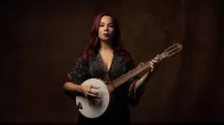 Rhiannon Giddens poses with her banjo. 