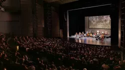 The Harris Theater auditorium full of patrons watching a performance.