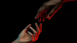 Two hands reaching for each other.
