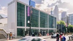 The Harris Theater exterior with a busy street. 