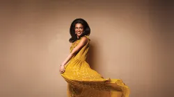 A woman twirling her yellow dress.