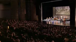 The Harris Theater auditorium full of patrons watching a performance.