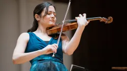 A woman playing the violin. 