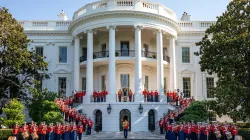 The United States Marine Band posing in front of the White House.