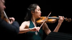 A woman playing the violin. 