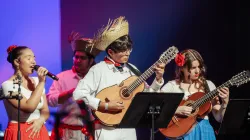A few young musicians playing the Cuatro guitar and singing. 
