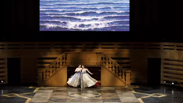 Soprano Cynthia Smithers and Soprano Mireille Asselin in dresses in between two stair cases