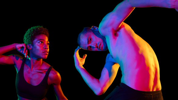 Two dancers from Hubbard Street Dance with a black background