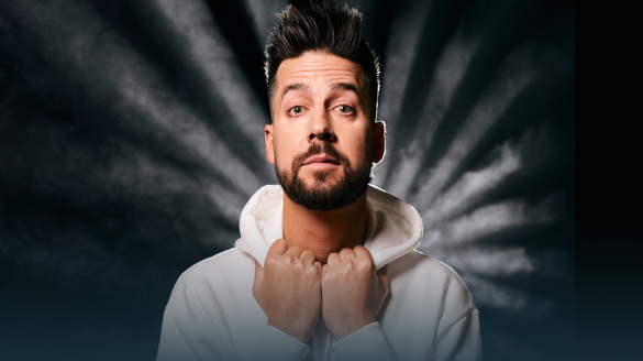 John Crist holding the front of his hoodie with both hands.