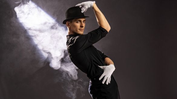 Dancer wearing a hat and white gloves