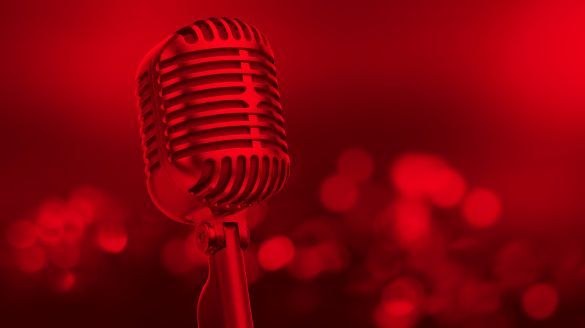 An image of a microphone with a red tint on the entire image.