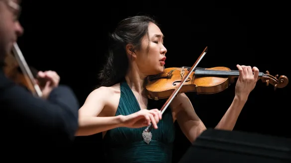 A woman playing the violin. 