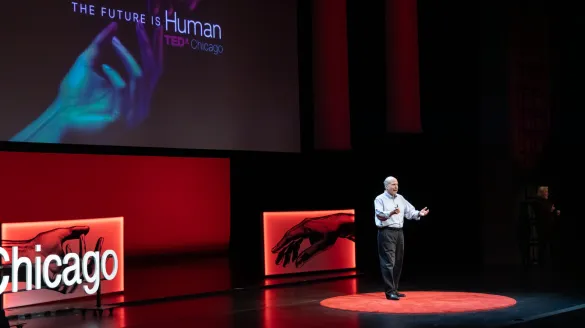 A man speaking on stage during the TEDX conference. 