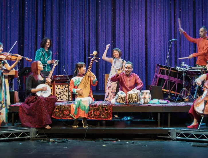 An ensemble of performers playing an assortment of instruments.
