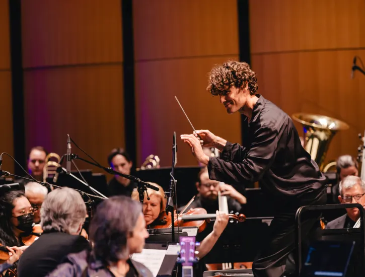 Steve Hackman conducting an orchestra.
